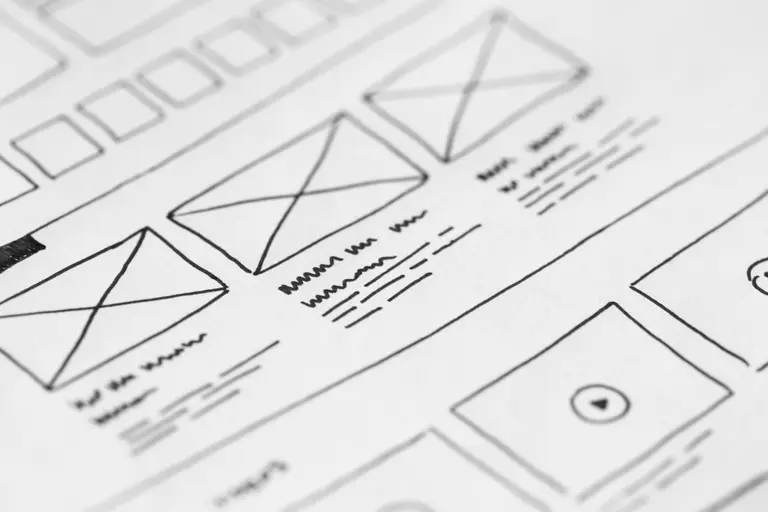 Hand-drawn website wireframes on white paper