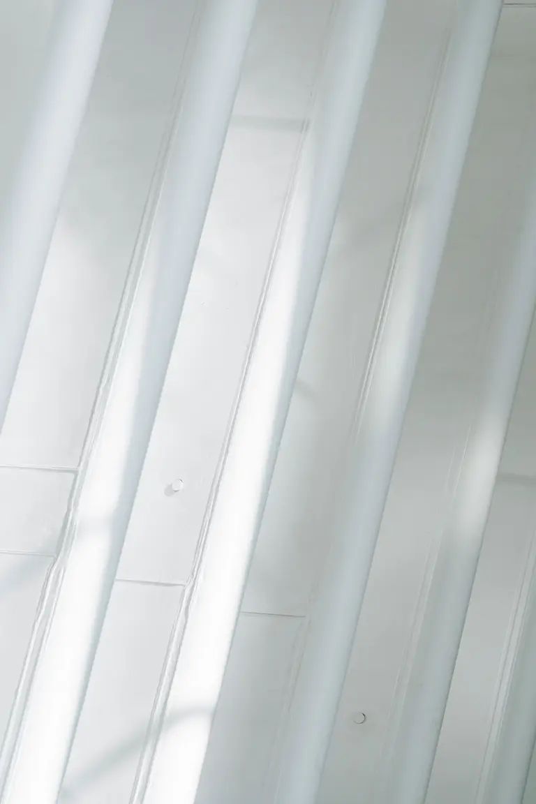 Tall white architectural surfaces catching soft light
